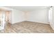 Open-concept living room with wood-look floors with view to the entryway and a staircase at 286 Lar Lan Dr, Danville, IN 46122