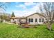 Expansive backyard features a brick patio, a small covered area, and lush green grass under a bright, sunny sky at 301 Lancelot Dr, Franklin, IN 46131