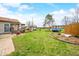 An expansive backyard with a well-manicured lawn, patio, and storage shed at 301 Lancelot Dr, Franklin, IN 46131