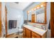 Charming bathroom with a wood-framed mirror, classic vanity, and a door to a linen closet at 301 Lancelot Dr, Franklin, IN 46131