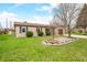 Charming brick home with well-manicured lawn, garden beds, and a driveway leading to an attached garage at 301 Lancelot Dr, Franklin, IN 46131