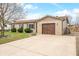 Charming brick home featuring a large driveway, an attached garage, and well-maintained landscaping at 301 Lancelot Dr, Franklin, IN 46131