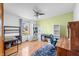 Bright office space featuring hardwood floors, a ceiling fan and a large window at 301 Lancelot Dr, Franklin, IN 46131