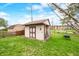 A backyard shed provides extra outdoor storage and is surrounded by a green lawn at 301 Lancelot Dr, Franklin, IN 46131
