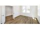 Bright bedroom features wood-look flooring, ample natural light from a large window, and a neutral color palette at 3241 Fawn Cir, Brownsburg, IN 46112