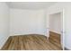 Well-lit bedroom boasts wood-look flooring, neutral wall color, and double doors leading to another room at 3241 Fawn Cir, Brownsburg, IN 46112