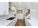 Contemporary kitchen showcasing stainless steel appliances, wood-look floors and crisp white cabinets at 3241 Fawn Cir, Brownsburg, IN 46112