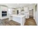 Modern kitchen featuring white cabinetry, stainless steel appliances, a center island and wood-look flooring at 3241 Fawn Cir, Brownsburg, IN 46112