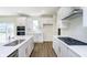 Stylish kitchen features stainless steel appliances, wood-look flooring and crisp white cabinets at 3241 Fawn Cir, Brownsburg, IN 46112