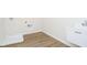 A laundry room featuring wood-look flooring and utility sink at 3241 Fawn Cir, Brownsburg, IN 46112