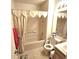 A full bathroom with shower-tub combination, toilet, sink, vanity, mirror, and neutral tile flooring at 3259 Eddy Ct, Indianapolis, IN 46214