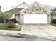 Charming home featuring a two-car garage with stone accents and a well-maintained front yard at 3259 Eddy Ct, Indianapolis, IN 46214