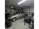 A two car garage currently stores an older model sedan, a walker, and various personal items at 3259 Eddy Ct, Indianapolis, IN 46214