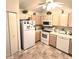 A bright kitchen features neutral cabinets, appliances, tile flooring and a ceiling fan at 3259 Eddy Ct, Indianapolis, IN 46214