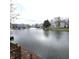 Scenic water view showcasing the tranquil lake surrounded by picturesque homes and lush greenery at 3259 Eddy Ct, Indianapolis, IN 46214