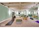 Finished basement featuring carpet floors, mirrored walls and modern workout equipment, ideal for fitness and recreation at 328 Millridge Dr, Indianapolis, IN 46290