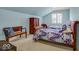 Attic bedroom with light blue walls, window, and matching bench at 328 Millridge Dr, Indianapolis, IN 46290