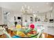 Open dining area with colorful chairs, hardwood floors, and views of kitchen and living room at 328 Millridge Dr, Indianapolis, IN 46290