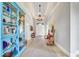 Elegant hallway featuring a chandelier, tiled floor, decorative cabinet, and stylish furnishings, creating a welcoming entrance at 328 Millridge Dr, Indianapolis, IN 46290