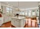 Bright kitchen with a central island, white cabinetry, hardwood floors, and stainless appliances at 328 Millridge Dr, Indianapolis, IN 46290