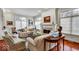 Cozy living room featuring a fireplace, hardwood floors, neutral sofas, and artful decor, enhancing the home's charm at 328 Millridge Dr, Indianapolis, IN 46290
