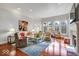 Bright living room featuring hardwood floors, large windows, and elegant decor and a fireplace at 328 Millridge Dr, Indianapolis, IN 46290