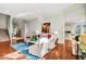 Open-concept living room with hardwood floors, bright natural light, and stairs and kitchen view at 328 Millridge Dr, Indianapolis, IN 46290
