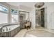 This elegant bathroom features a vanity, modern fixtures, a soaking tub, and a glass shower at 328 Millridge Dr, Indianapolis, IN 46290