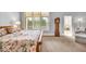 Spacious main bedroom features a carpet floor, a large window, and a grandfather clock at 328 Millridge Dr, Indianapolis, IN 46290