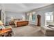 Spacious main bedroom boasts an ensuite bathroom, a carpet floor, and bright windows at 328 Millridge Dr, Indianapolis, IN 46290