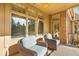 Covered patio area with comfortable seating, perfect for relaxing and enjoying the outdoors with a brick accent wall at 328 Millridge Dr, Indianapolis, IN 46290
