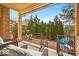 Covered patio with wrought iron railing offering a tranquil outdoor space overlooking a landscaped backyard at 328 Millridge Dr, Indianapolis, IN 46290