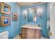 Stylish powder room with bright blue wallpaper and a designer mirror at 328 Millridge Dr, Indianapolis, IN 46290