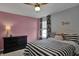 Charming bedroom with ceiling fan, a comfortable bed, and bright natural light from the window at 3341 Suffolk Ct, Greenwood, IN 46143