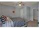 Cozy bedroom showcasing neutral colors and accents, with ceiling fan and comfortable bedding at 3341 Suffolk Ct, Greenwood, IN 46143