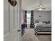 Bright bedroom with plush carpet, ceiling fan, and comfortable black and white striped bedding at 3341 Suffolk Ct, Greenwood, IN 46143