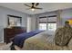 Light filled bedroom with a ceiling fan, a dresser, a large mirror and a comfortable looking bed at 3341 Suffolk Ct, Greenwood, IN 46143