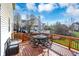 Enjoy outdoor dining on this wood deck with wrought iron table and chairs with scenic views at 3341 Suffolk Ct, Greenwood, IN 46143