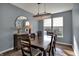 Elegant dining room featuring a modern chandelier, a decorative mirror, and a spacious dining table at 3341 Suffolk Ct, Greenwood, IN 46143