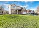 Suburban home featuring a wide lawn, a brick and siding facade, and a paved driveway under a cloudy sky at 3341 Suffolk Ct, Greenwood, IN 46143