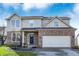 Charming two-story home featuring a brick facade and a well-manicured lawn under a bright, cloudy sky at 3341 Suffolk Ct, Greenwood, IN 46143