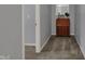 A cozy hallway features neutral colored walls, plush carpeting, and a quaint desk with decorative items at 3341 Suffolk Ct, Greenwood, IN 46143
