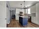 A stylish kitchen with white cabinets, stainless steel appliances, and a blue island at 3341 Suffolk Ct, Greenwood, IN 46143