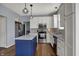 Kitchen featuring stainless steel appliances, island, white cabinets, and modern lighting at 3341 Suffolk Ct, Greenwood, IN 46143