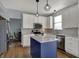 Kitchen featuring a center island with modern pendant lighting, white cabinetry, and stainless appliances at 3341 Suffolk Ct, Greenwood, IN 46143