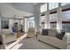 Bright living room with vaulted ceiling, large windows, and comfortable seating, open to the kitchen at 3341 Suffolk Ct, Greenwood, IN 46143