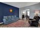 Comfortable living room featuring a blue couch, hardwood floors, and an elegant sunburst wall decor at 3341 Suffolk Ct, Greenwood, IN 46143