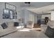 Open living space with neutral tones, gallery wall, and hardwood floors leading to the kitchen at 3341 Suffolk Ct, Greenwood, IN 46143