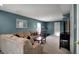 Relaxing living room with large comfortable couch, a TV, and a mirrored wall hanging at 3341 Suffolk Ct, Greenwood, IN 46143