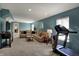 Relaxing living room with a cozy sectional sofa, carpeted floors, and a modern treadmill for exercise at 3341 Suffolk Ct, Greenwood, IN 46143